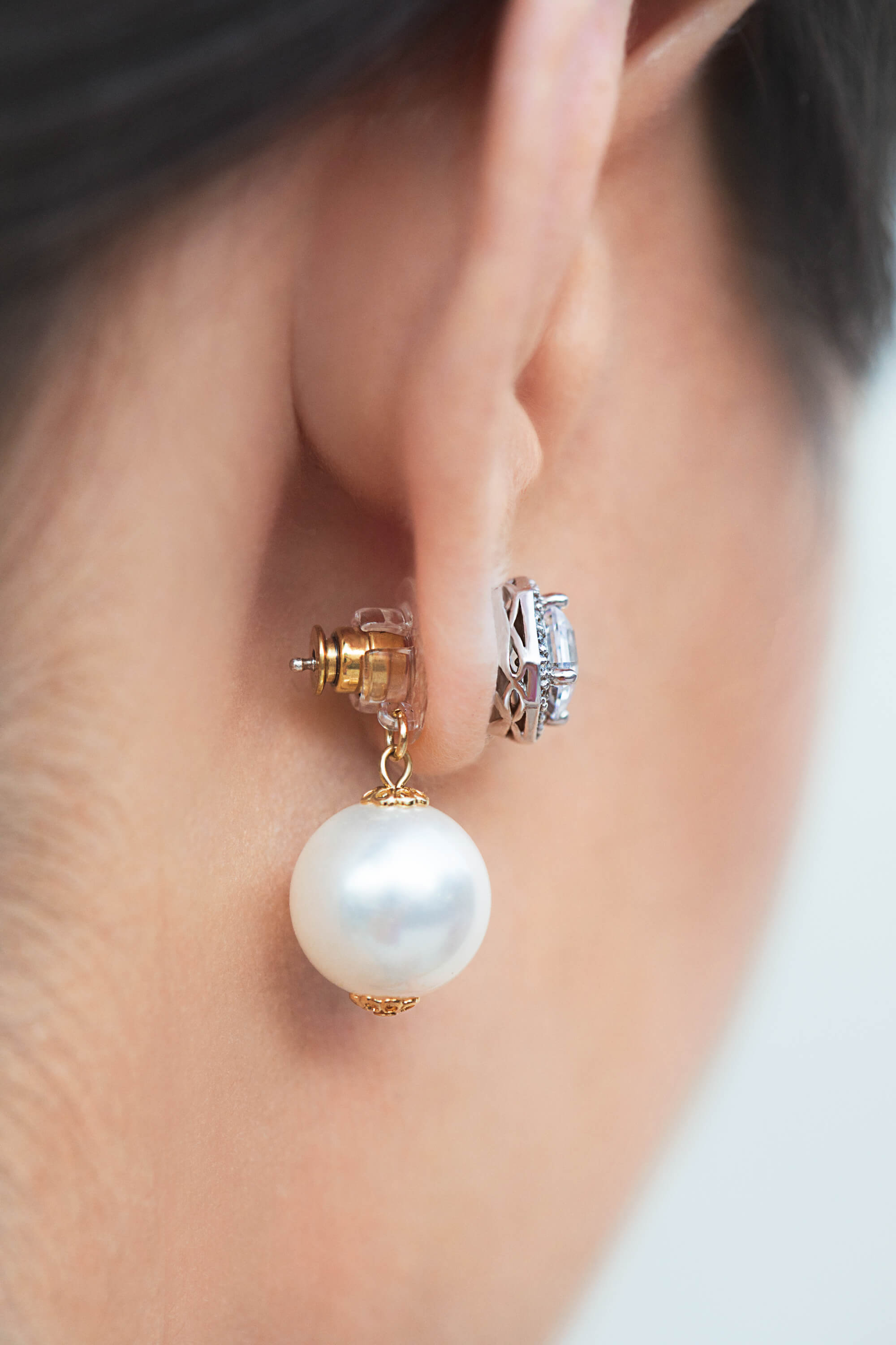 Close up of woman's earlobe wearing Chrysmela Catch Earring Backs with discs