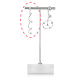 Platinum earring jackets on earring stand against white background